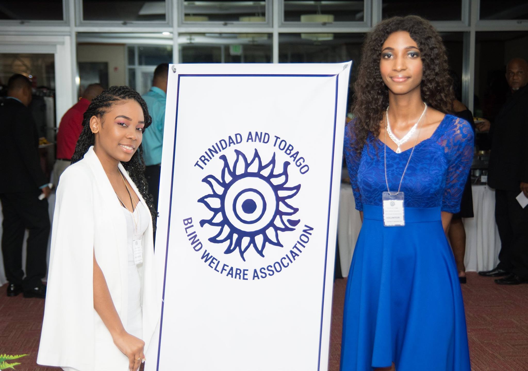 Photo of 2 girls in front of the association's poster