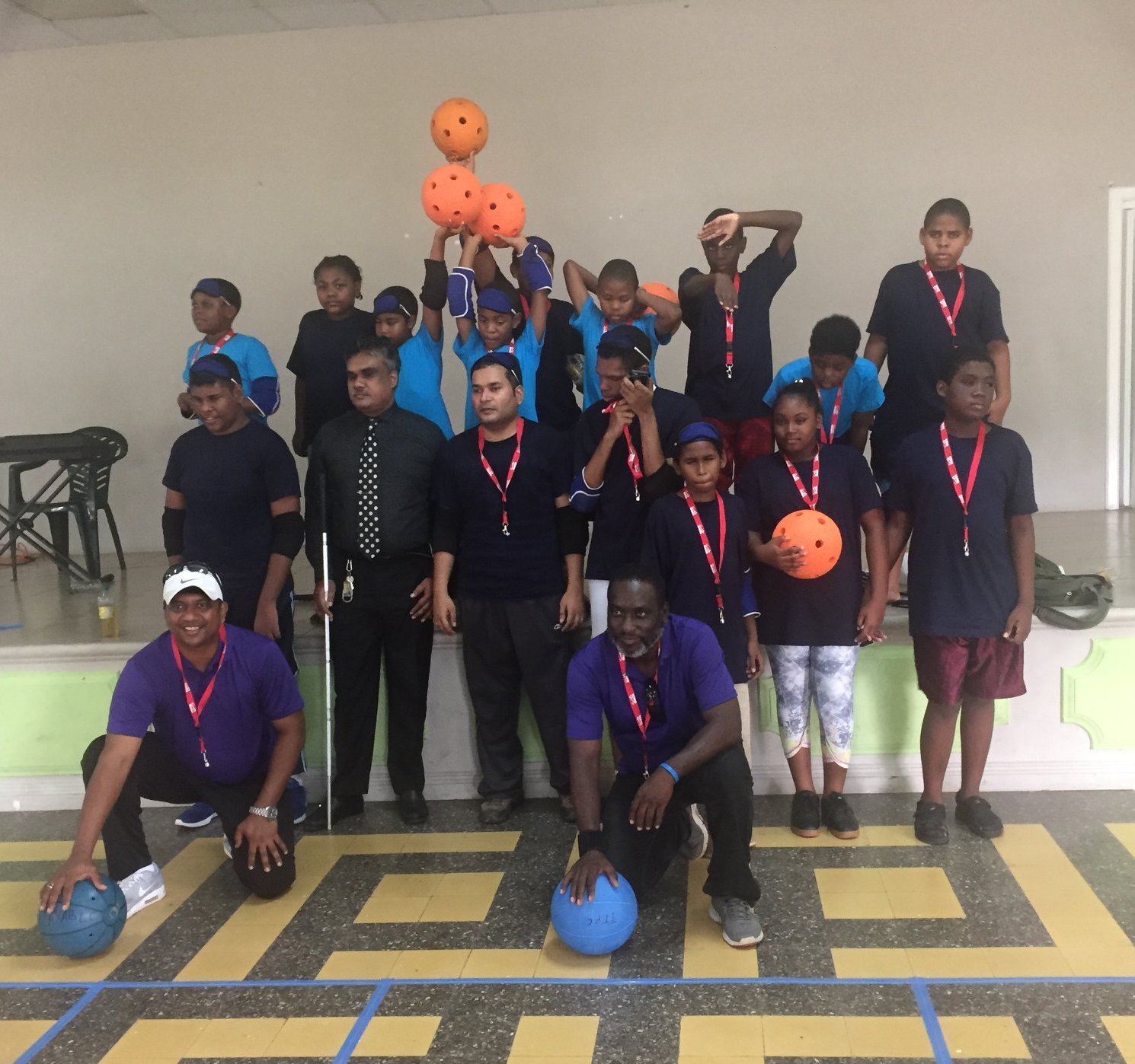 Photo of a group of people with balls and protection equipment